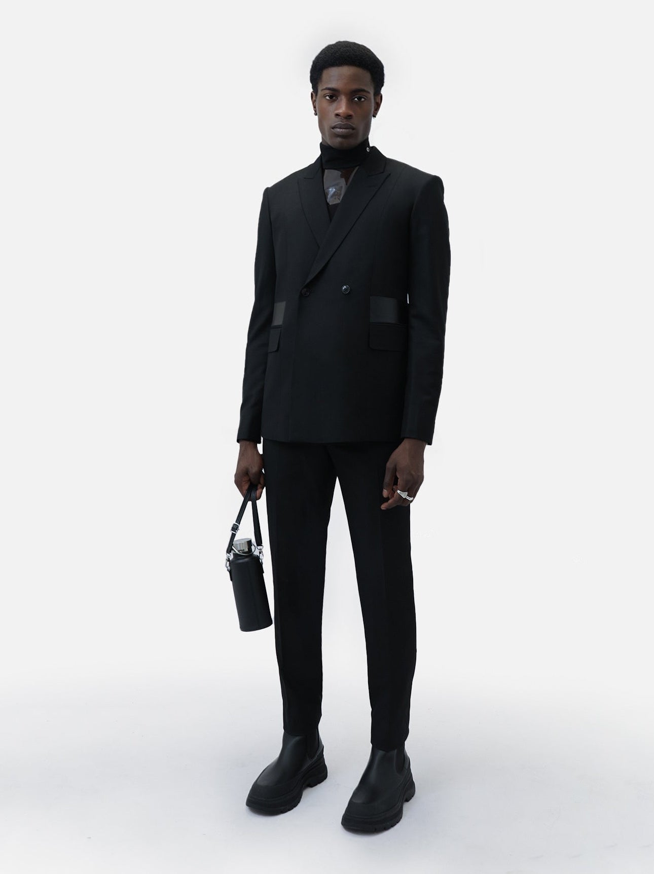 Man wearing a black suit with a white background